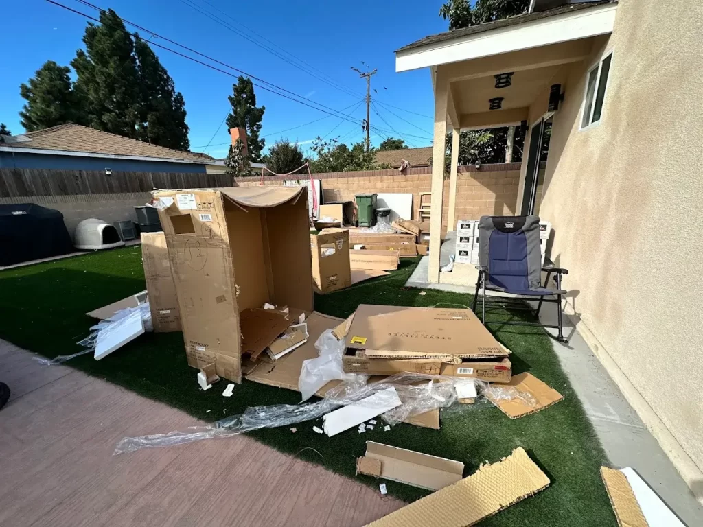 pile of cardboard boxes outside house